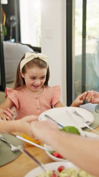 Praying, lunch and holding hands with child in home for connection, religion and support. Faith, gratitude and worship with kid and food in dining room of family house for grace, blessing and love