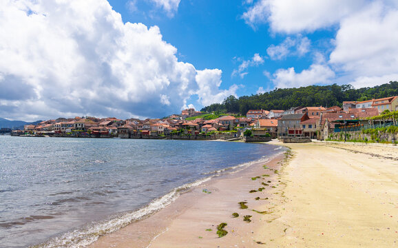 beautiful scenic view of combarro coastal old town village in Galicia spain with sandy beach and stone h&oacute;rreos granaries along the sea. Travel destination in Spain