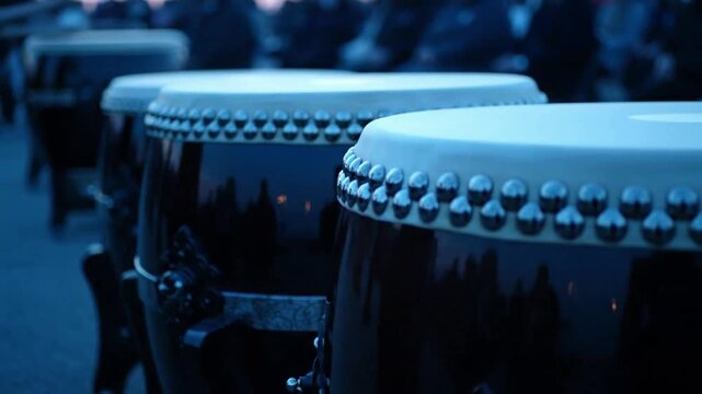 Drums with white tops and metal studs lined up