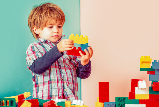Colorful toy blocks. Educational toys for young children. Little boy playing with lots of colorful plastic blocks constructor