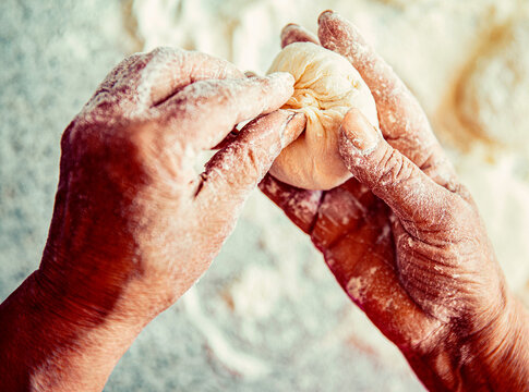 Cakes dough in the women's hands. Process of making pies, hand. Hands pie dough. Cooks dough for baking
