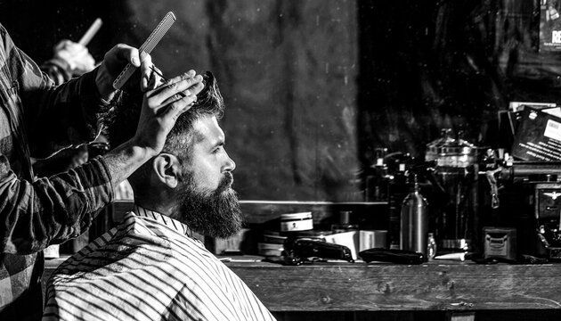 Barber shop. Man visiting hairstylist in barbershop. Bearded man in barbershop. Work in the barber shop. Black and white