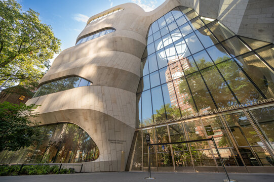 New york, usa august 19,2024. American museum of natural historys new building, with a unique undulating stone facade and reflective glass entrance on a sunny day