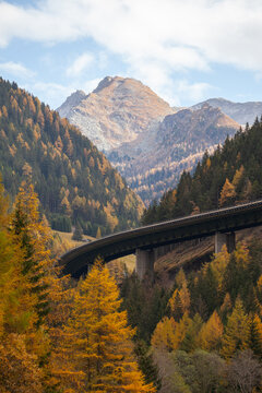 The famous Brenner Pass highway bridge in autumn surroundings with alpine mountains. Gries am Brenner, Tyrol, Austria.