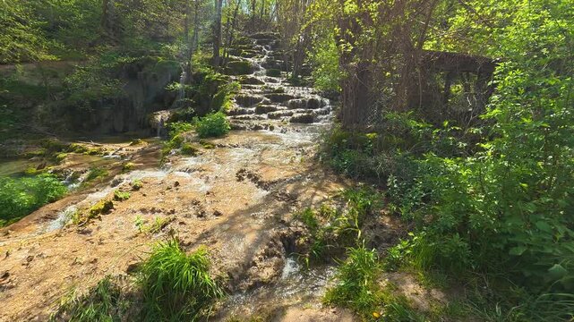 Sunlit stream cascades over mossy stones. Bigar Waterfall, Stara Planina. (Balkan Mountains), Serbia.