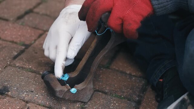Applying high performance anti squeal lubricant to caliper contact points during pad installation. Advanced automotive maintenance reducing vibration and unwanted noise in moving components. DIY