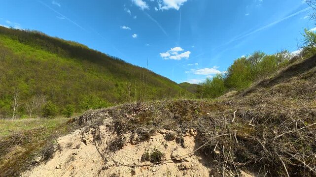 Dirt path winds through grassy hills. Bigar Waterfall, Stara Planina. (Balkan Mountains), Serbia.