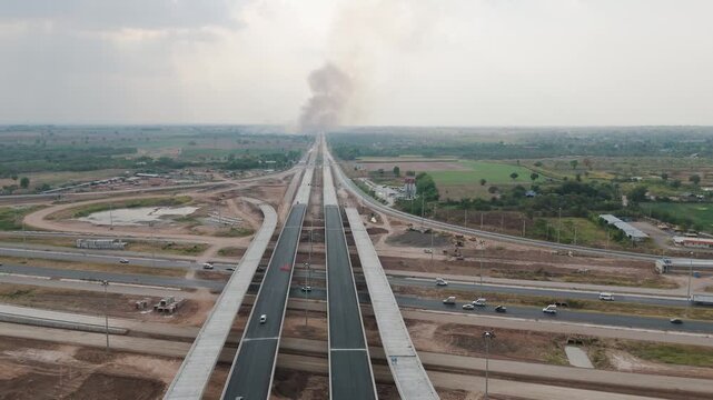 Drone footage under construction cross bridge and highway road with the traffic at the rural place