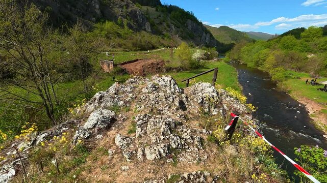 Rocks overlook a river winding through green hills. Temska River, Stara Planina. (Balkan Mountains), Serbia.