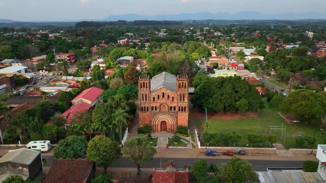Panoramic backward aerial of iconic Our Lady of Asuncion historic church in Villarrica, Paraguay