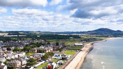 Fototapeta premium Aerial View of Fife Coastal Town with Sandy Beach and Hills