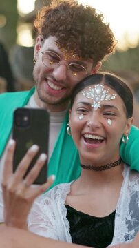 Couple, selfie and happy at festival, outdoor and glitter with hug, bonding and summer holiday. People, partner and photography with smile, memory or mobile app for social network on spring break