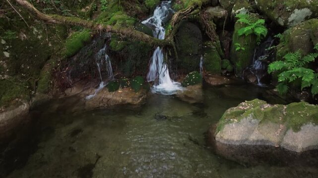 Cascada de Santo Estevo do Ermo Waterfalls Over The Rocky Mountains In Barreiros, Galicia, Spain. Aerial Tilt-up Shot