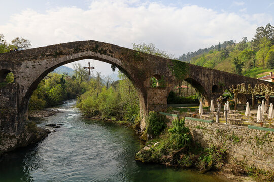 The Roman bridge over The Sella river as it passes through Cangas de Onis town, Asturias, Spain