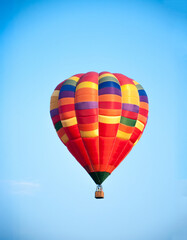 Naklejka premium Hot air balloon in the sky. Aeronautics. Against the background of the blue sky. Air sports.