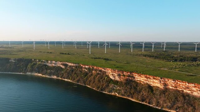 Wind turbines farm coastal cliff Black Sea Bulgaria aerial drone view alternative energy green technology summer clear sky renewable power generation tourism landscape panoramic shoreline nature Kalia