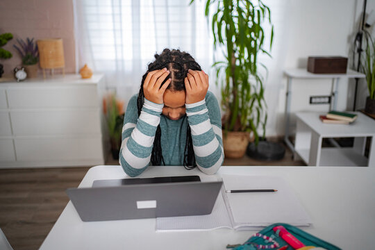 Frustrated student having headache during online studying