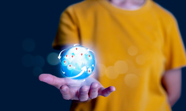 Person holding glowing digital globe with network connections and technology icons, representing global communication, artificial intelligence, and futuristic innovation concept.