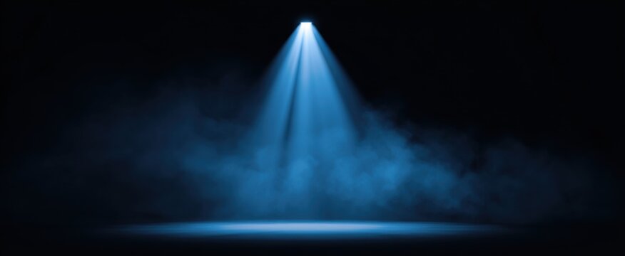 Intense Blue Spotlight Beam cutting through fog for dramatic illumination effects.