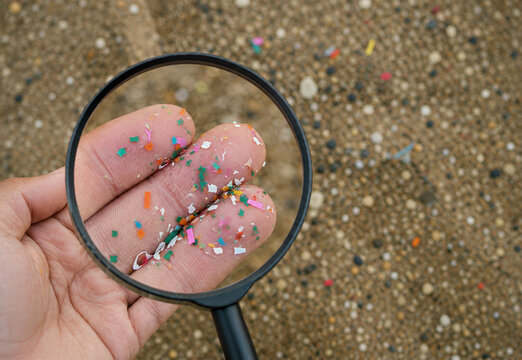 Close up side shot of microplastics lay on people hand. Concept of water pollution and global warming. Climate change idea. micro plastics concept in food and water or sea