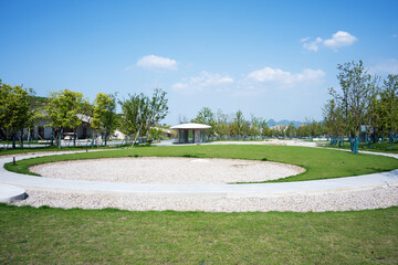 Fototapeta premium Circular landscape view in park green space under blue sky and white clouds