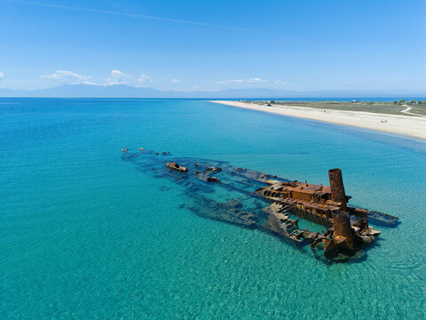 Aerial view of Shipwreck Epanomi in turquoise waters along a sandy coastline under a clear blue sky Epanomi, Greece.