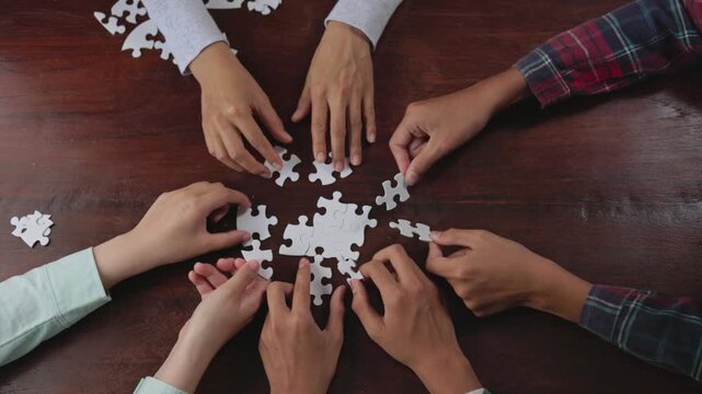 Top view close up shot of professional successful group of  Hand holding jigsaw puzzles, Business partnership concept. Business teamwork with puzzle togetherness collaboration.