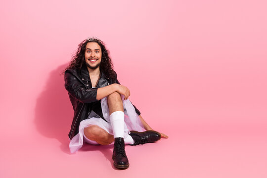 Confident LGBT non-binary dancer in a pink studio wearing a leather jacket and tutu, showcasing bold fashion