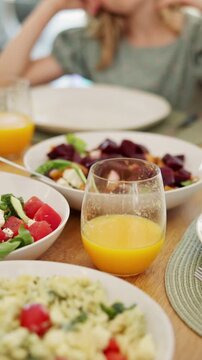 Food, feast and child at dining table for lunch, healthy meal and cuisine selection for nutrition. Weekend buffet, vegetables and girl with balanced diet for wellness, family home and homemade dish