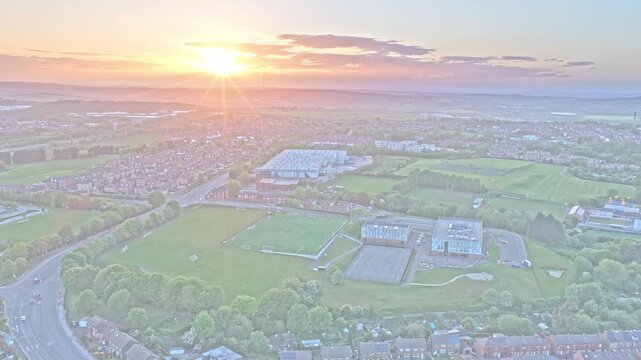 Community soccer pitches near Locke Park, Park Road, Barnsley South Yorkshire, Yorkshire and the Humber, England, aerial drone sunset shot above recreational grounds and suburban landscape.