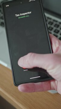 Stressed man trying to dismiss scam or government tax inspector phone call on mobile device