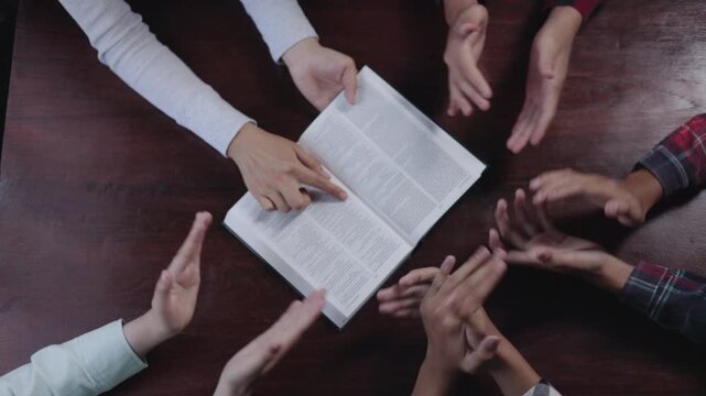 People or families are Christmas celebration. Christian group pray worship praise together with sing and guitar in church. Hand and bible prayer concept.