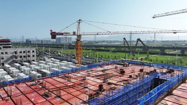 Tower crane and steel reinforcement bars on a construction site under blue sky