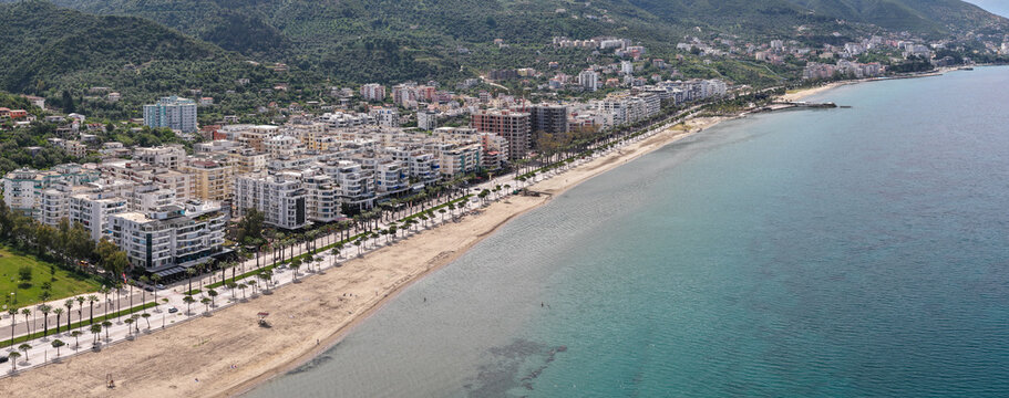 Aerial image of Vlora, Albania, capturing the extensive sandy coastline and the palm-lined promenade.