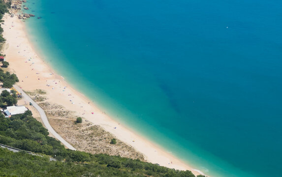 Beautiful landscape. Top view to amazing Atlantic Ocean shore, near Setubal, Portugal. Wonderful bay with azure clear water and small stony island Anixa. Beach Portinho da Arrabida or Praia do Creiro.