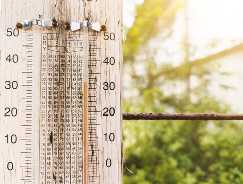 Wooden thermometer and hygrometer are installed outside to measure the temperature and humidity of the environment.
