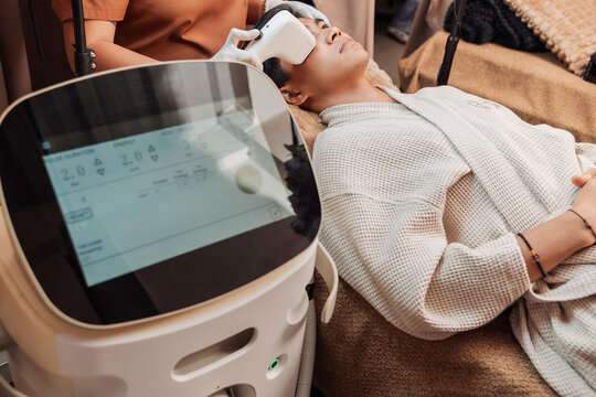 Male client undergoing 2D HIFU facial treatment in an aesthetic clinic for noninvasive skin tightening and facial contour enhancement.