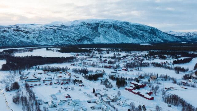 Alta, Norway. Aerial view of small northern town Alta, Norway in winter. Aerial time-lapse with houses, river and mountain in the evening, panning video