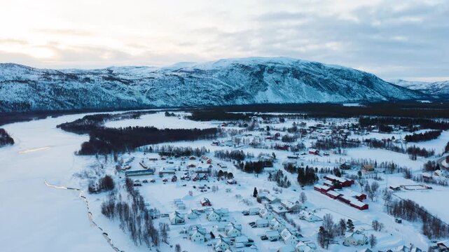Alta, Norway. Aerial view of small northern town Alta, Norway in winter. Aerial time-lapse with houses, river and mountain in the evening
