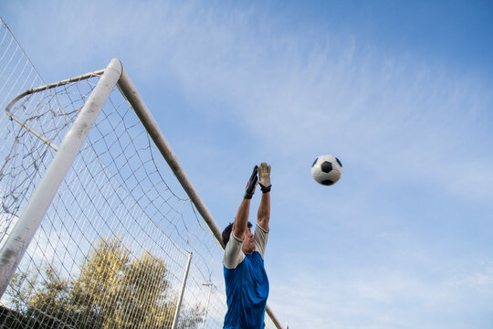 Football goalkeeper making a safe