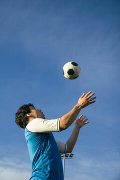 Football player with ball in the air