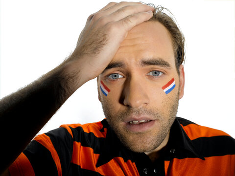 Man with Holland flag painted on face, portrait