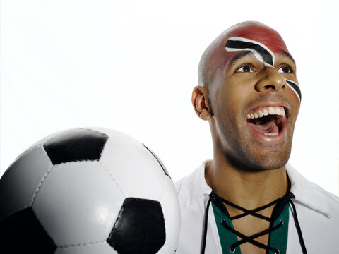 Football fan with Trinidad and Tobago flag painted on face