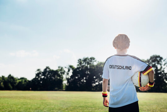 Boy wearing football shirt with Germany written on back