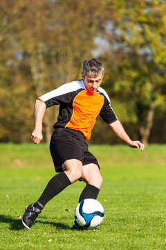 Soccer player with ball on field