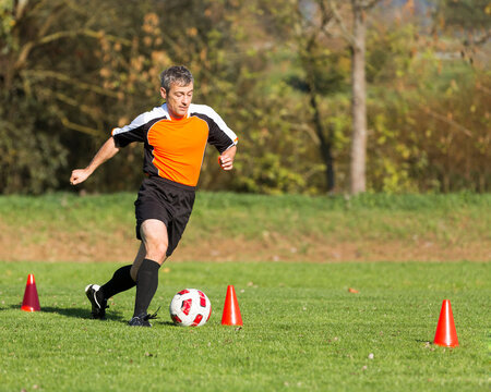 Soccer player passing a slalom course