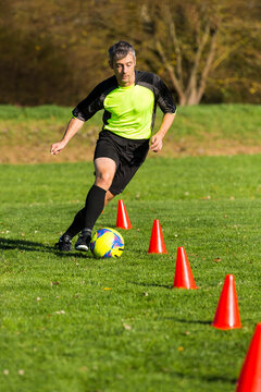 Soccer player passing a slalom course