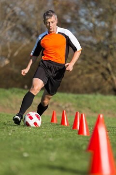 Soccer player passing a slalom course