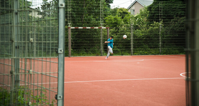 Boy on soccer field shooting ball