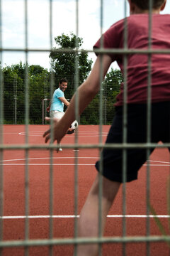 Germany, Mannheim, Father and son playing soccer